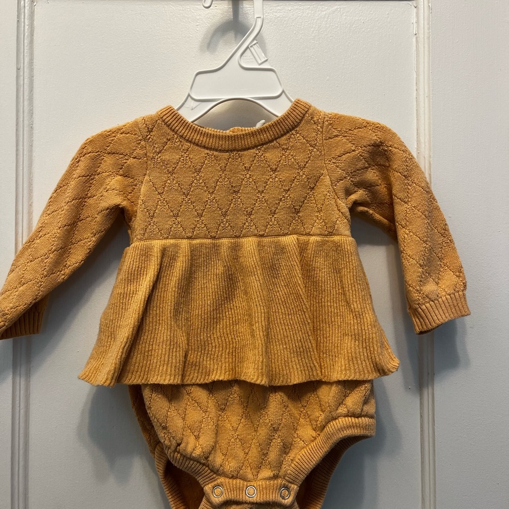 Kate Quinn peach colored onesie w ruffles
